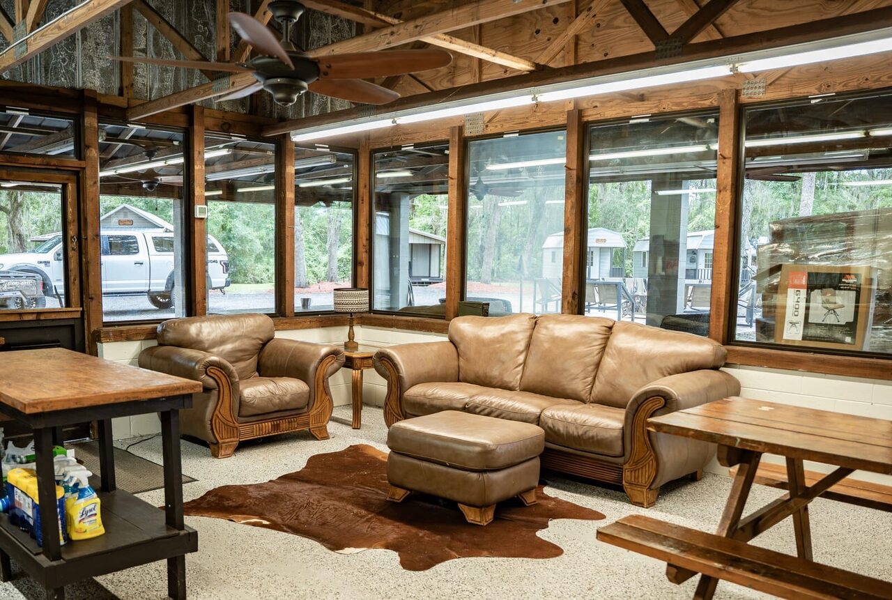 Leather couches and common lounge area inside the lodge at Brawler Creek Ranch