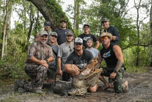 A crew of gator hunters with their harvested alligator at Brawler Creek Ranch